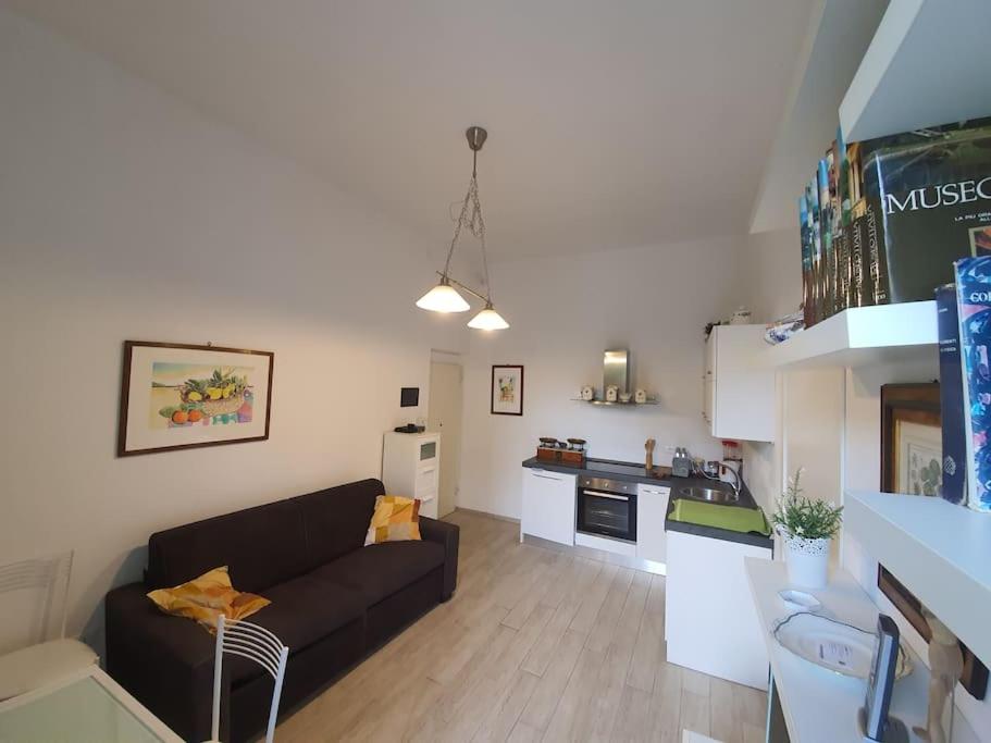 a living room with a couch and a kitchen at Casa del Golfo in Riccò del Golfo di Spezia