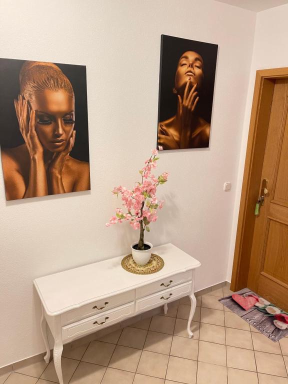 a room with a white table with a vase on it at ZumGlückFrei in Passau