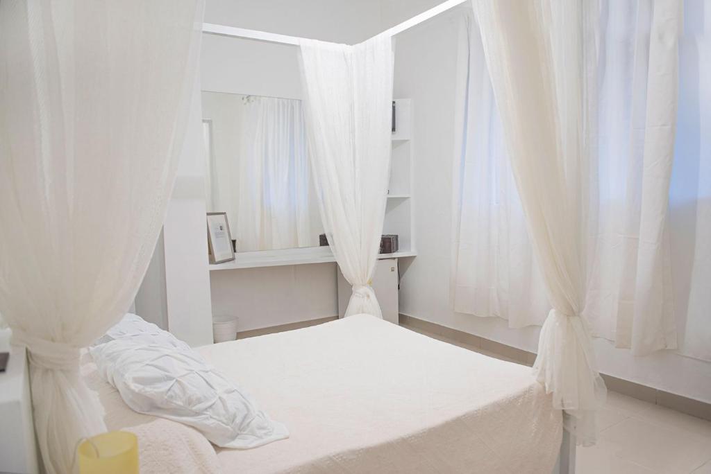 Postel nebo postele na pokoji v ubytování Hostal Mamà Mambò - Zona Colonial
