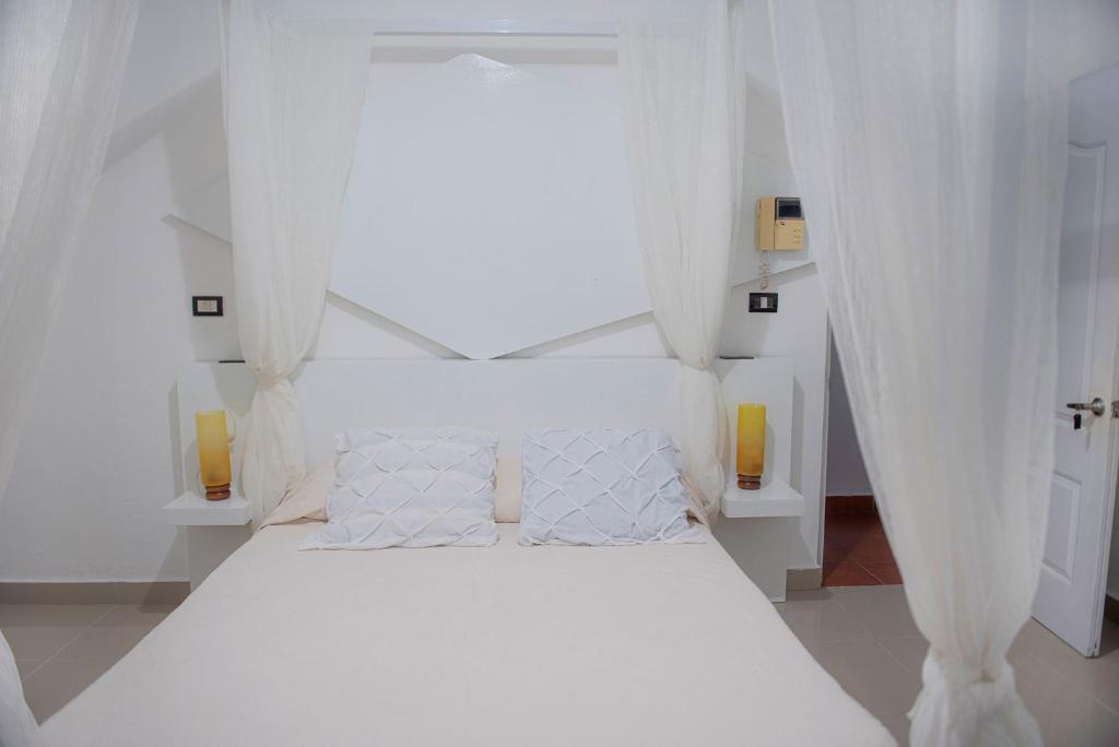 Postel nebo postele na pokoji v ubytování Hostal Mamà Mambò - Zona Colonial