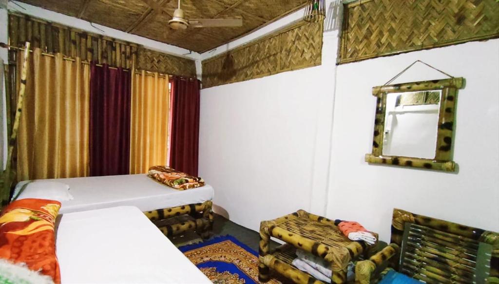 Voodi või voodid majutusasutuse Rupali Tat Ghar and Homestay toas