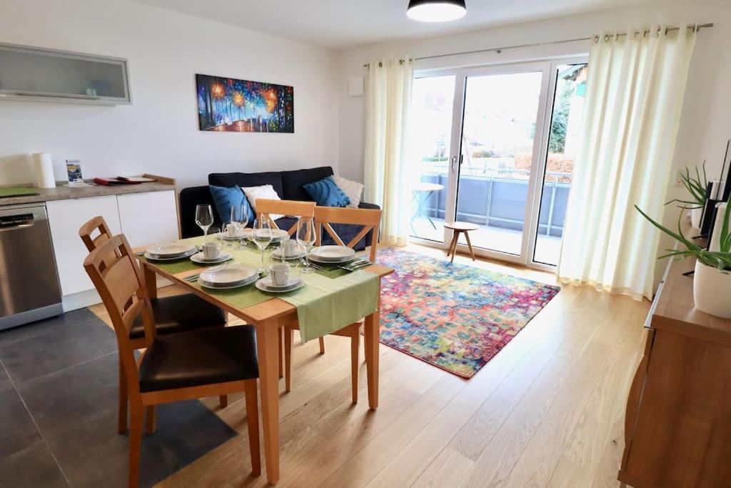 a kitchen and living room with a table and chairs at Modern Apartment, central in Bad Aibling in Bad Aibling