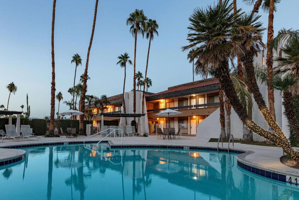 a hotel with a swimming pool in front of a building at Travelodge by Wyndham Palm Springs in Palm Springs