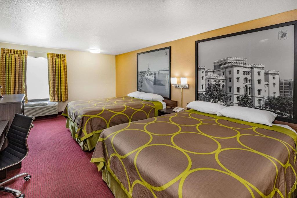a hotel room with two beds and a large window at Super 8 by Wyndham Kinder/Coushatta near Casino in Kinder