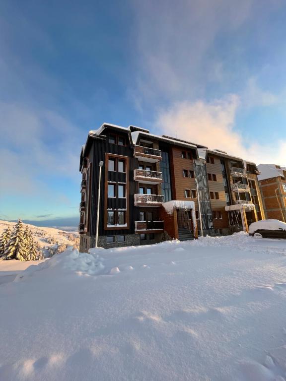 a building in the snow with a lot of snow at Vila Golija in Kopaonik