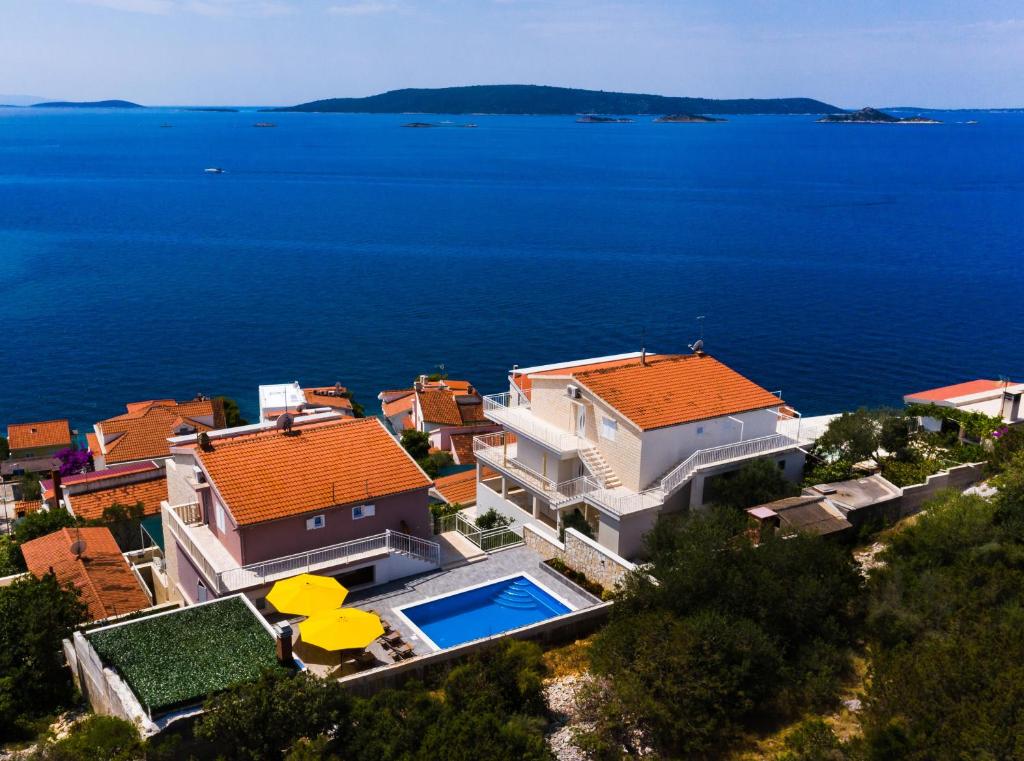 an aerial view of a house with a swimming pool at Apartments Care in Okrug Donji