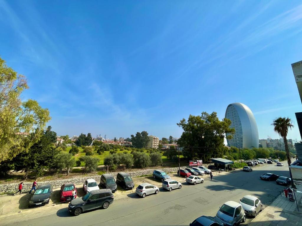 a parking lot with a lot of cars parked at Two Bedroom City Seaside Apartment in Limassol