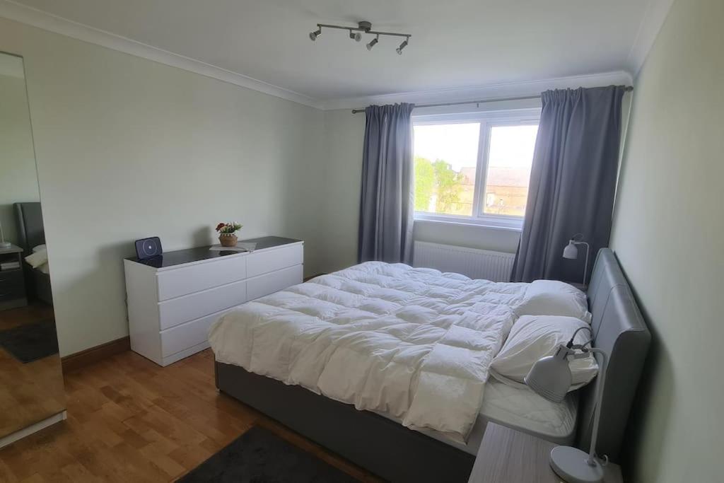 a bedroom with a bed and a window at Bright & Lovely & apartment in Whetstone