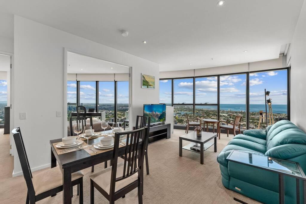 a living room with a dining table and a couch at Southbank CBD Apartment with Spectacular Views in Melbourne