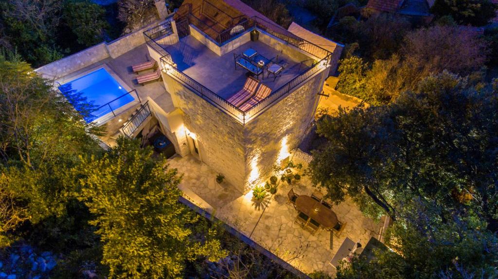 an overhead view of a house with lights at 19th Century stone art house in NATURE PARK in Makarska