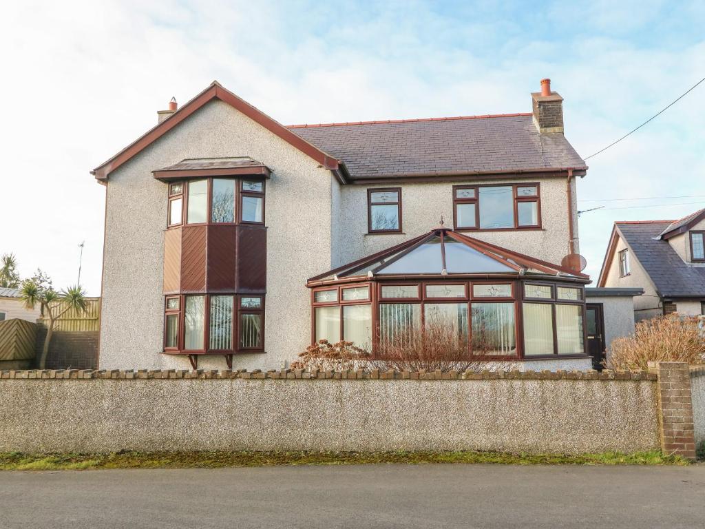 a house with a large window on top of a wall at Rhiangwyn in Holyhead