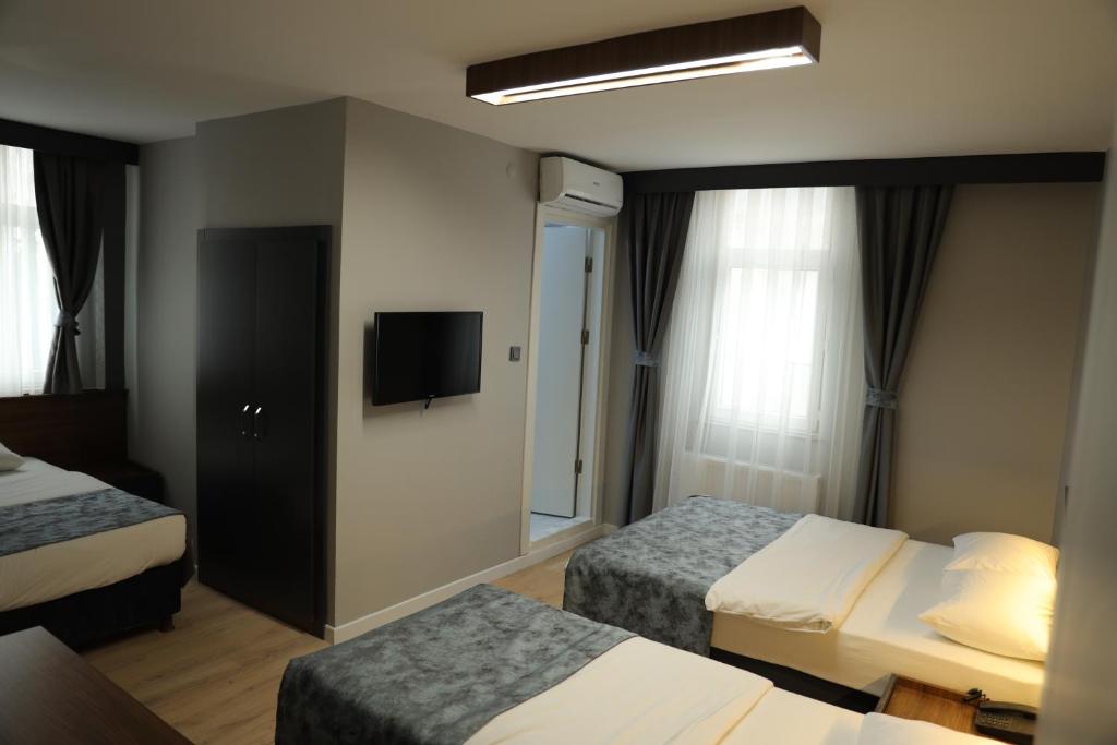 Postel nebo postele na pokoji v ubytování Turkuaz Hotel