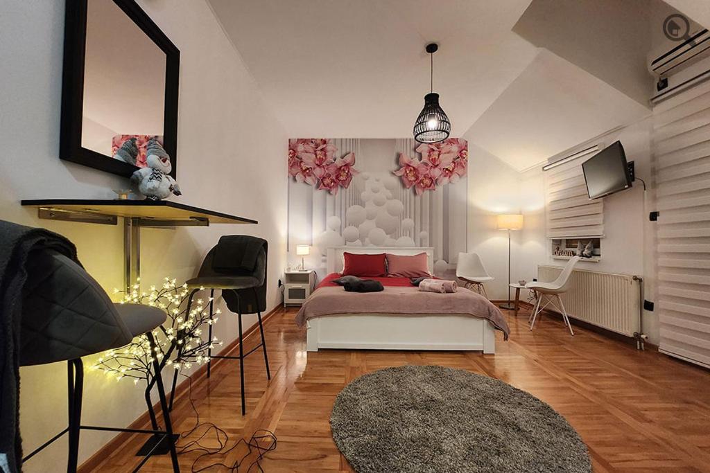a bedroom with a bed and a table and chairs at Gaga Gold in Belgrade