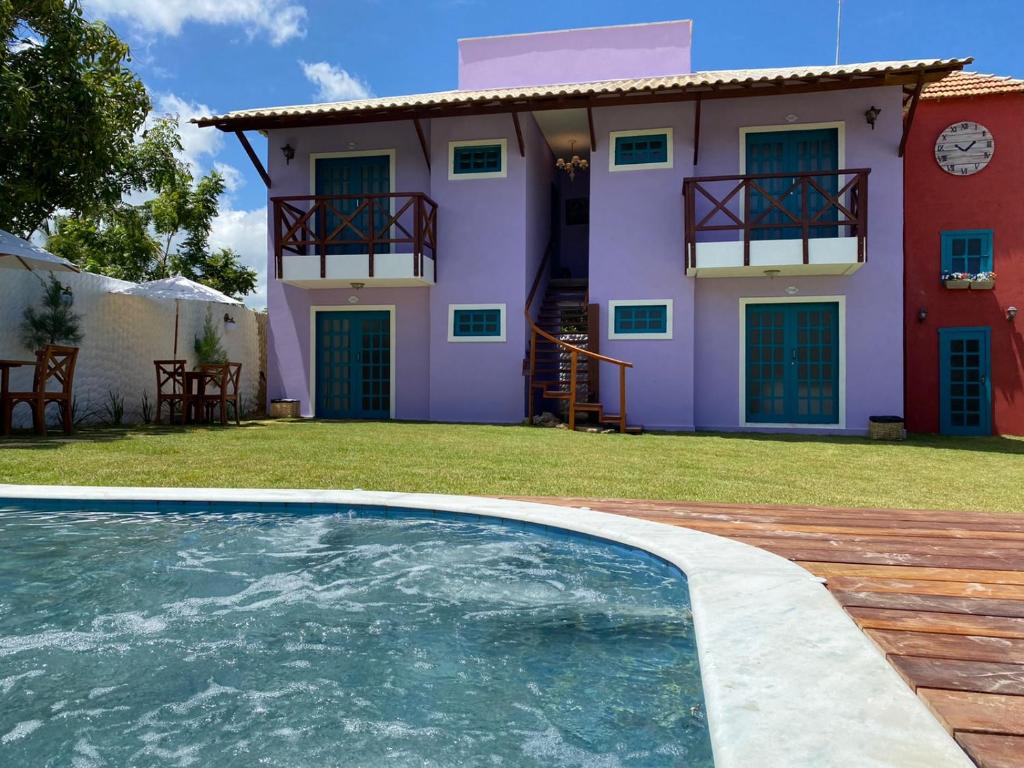 a house with a swimming pool in front of a house at Amoreira Pousada em Barra Grande Piaui in Barra Grande