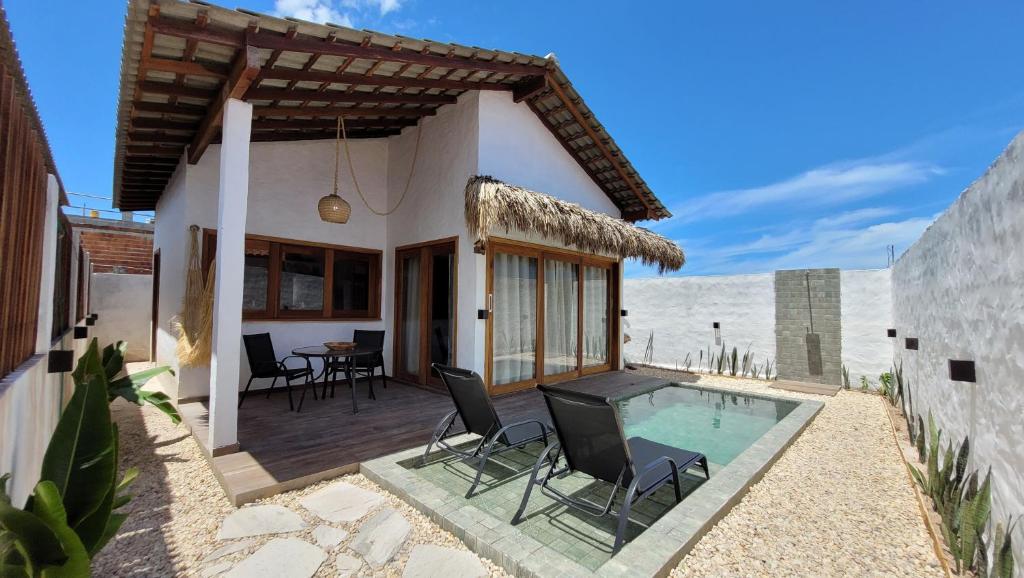 a villa with a swimming pool and a patio at BG Sol e Mar - Chalé Mar in Barra Grande