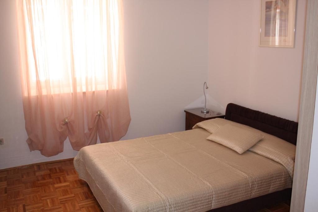 Łóżko lub łóżka w pokoju w obiekcie Apartments Tomato