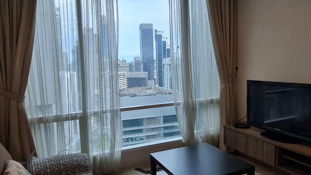 a room with a large window with a view of a city at SOHO SUITES KLCC by RED HOMES in Kuala Lumpur