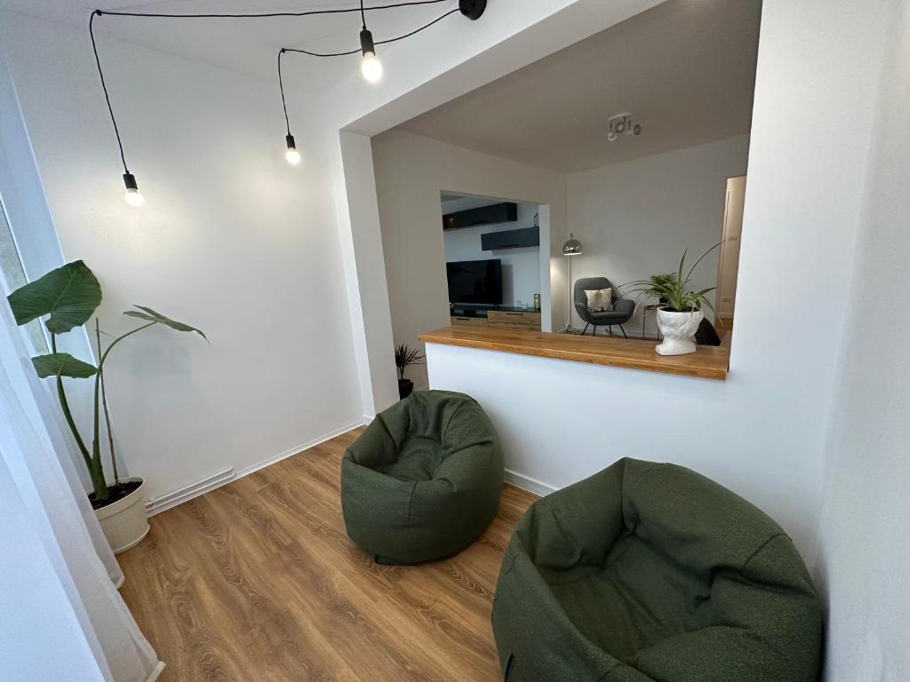 a living room with two chairs and a mirror at ESI Apartments #Central in Timişoara