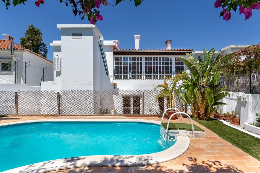 a swimming pool in front of a house at Lx Villa -10 m to downtown,14 ppl,cowork, pool and lift in Lisbon