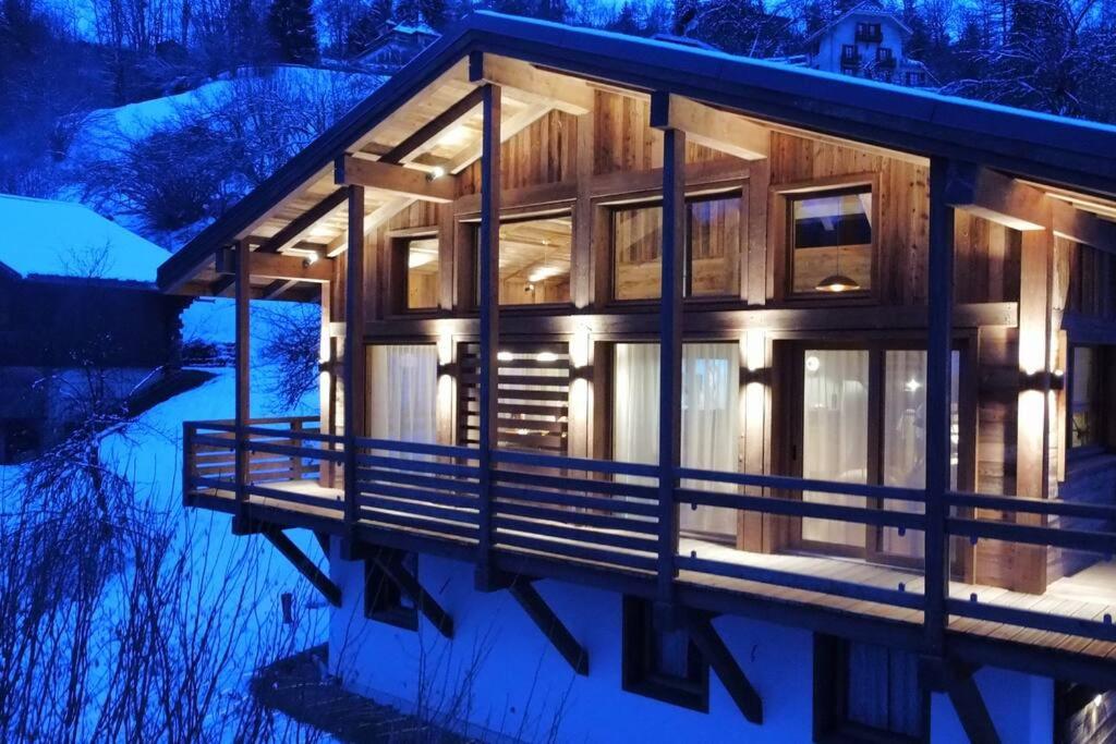 a log cabin in the snow at night at CHALET UTOPIA in Saint-Gervais-les-Bains