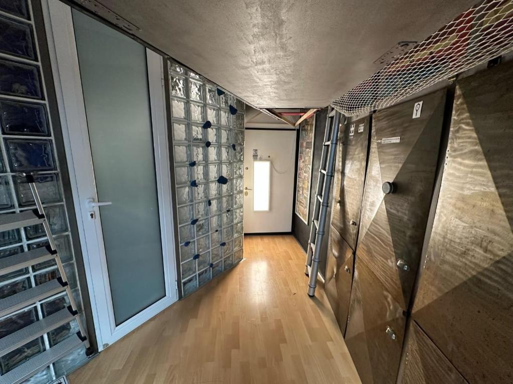 a hallway with wooden floors and a room with glass doors at Athens centre diamond in Athens