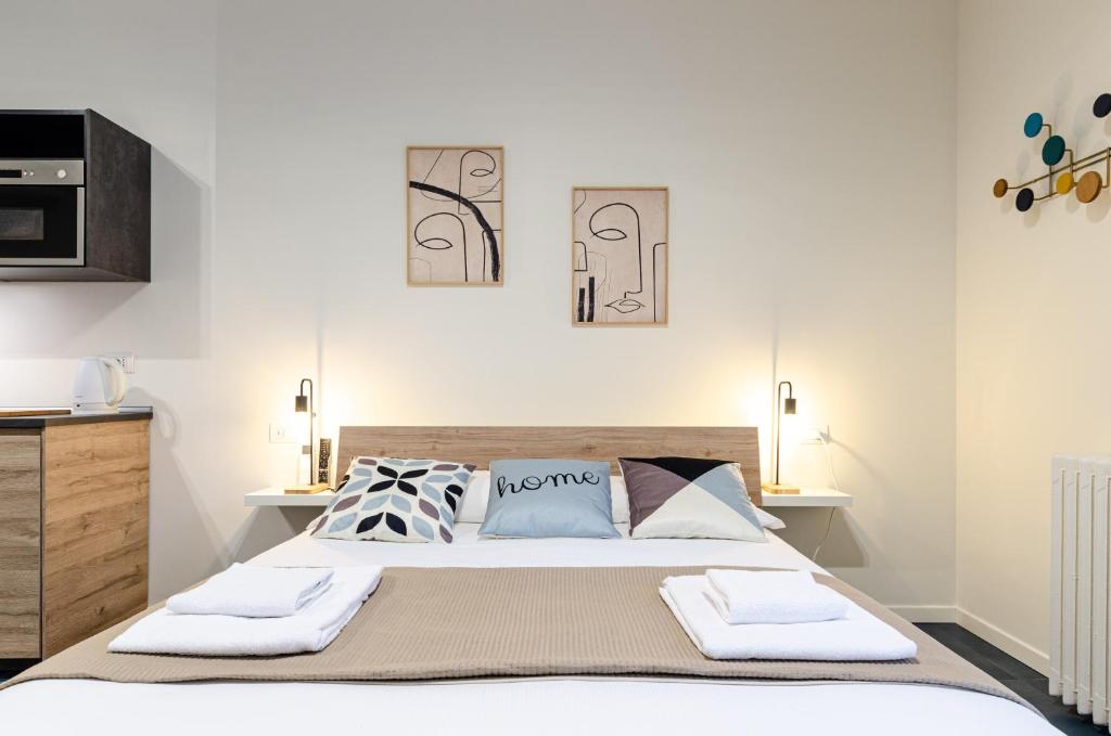 a bedroom with a bed with two towels on it at VELASQUEZ APARTMENTS - A - San Siro in Milan
