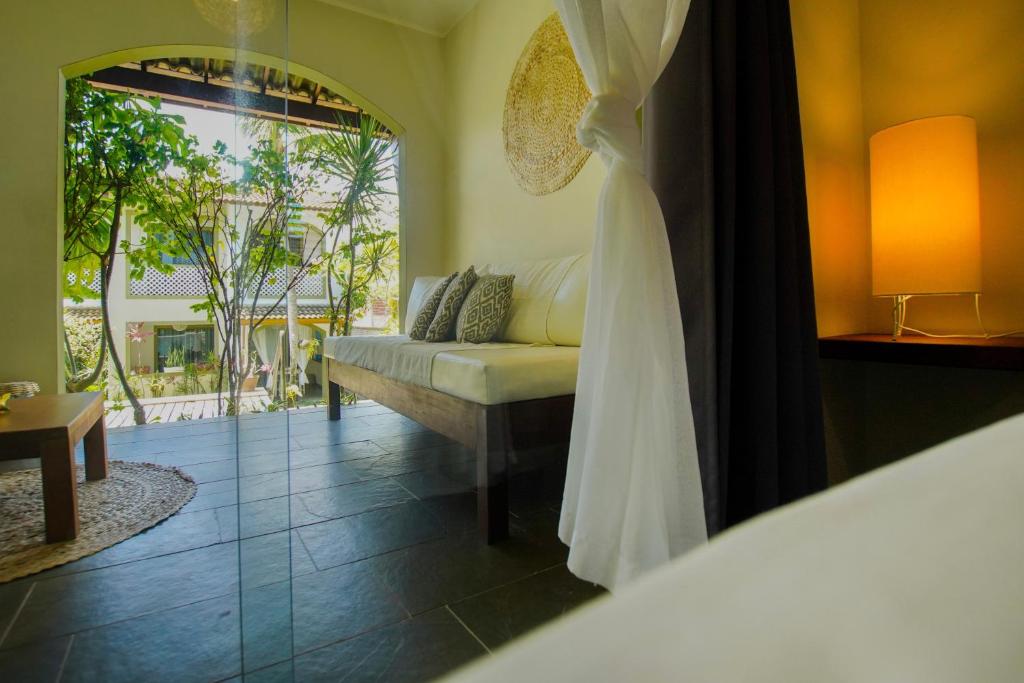 a room with a couch and a window at Flor da Mata in Pipa