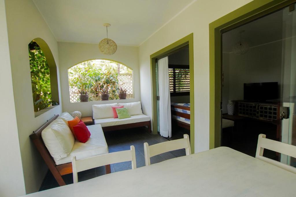 a living room with a couch and a table at Flor da Mata in Pipa