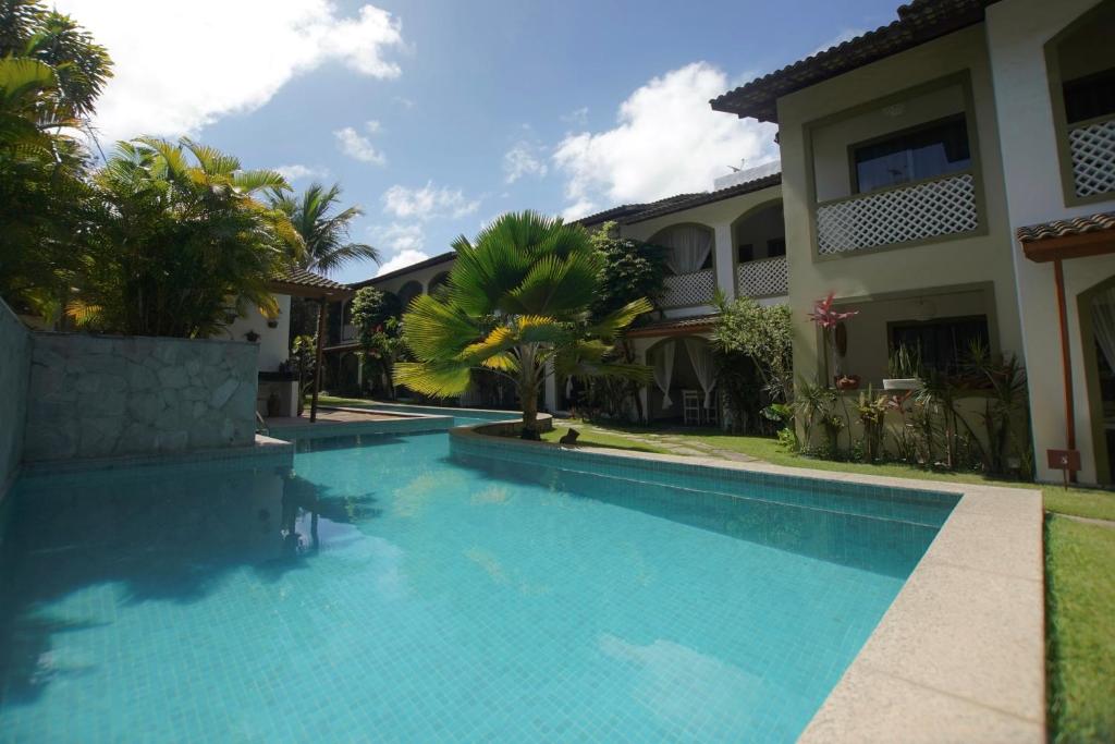 a swimming pool in front of a house at Flor da Mata in Pipa