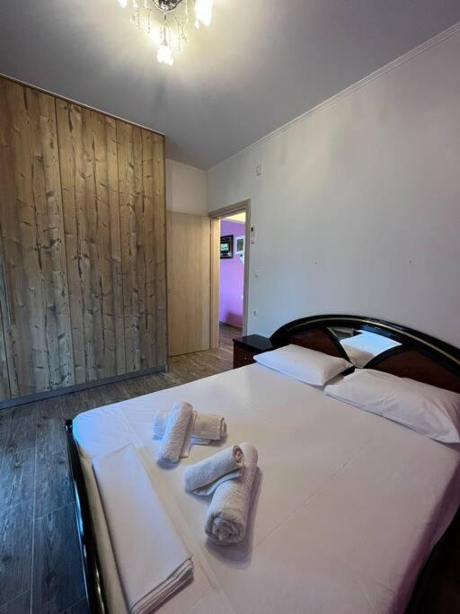 a bedroom with a large white bed with towels on it at Family Getaway Close the Sea in Ayía Marína