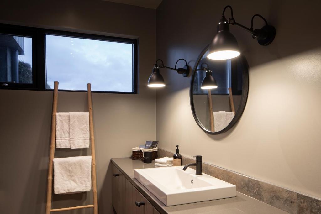 W łazience znajduje się umywalka i lustro. w obiekcie Hemrumork - Chalet upper (Efri torfa) w mieście Kirkjubæjarklaustur