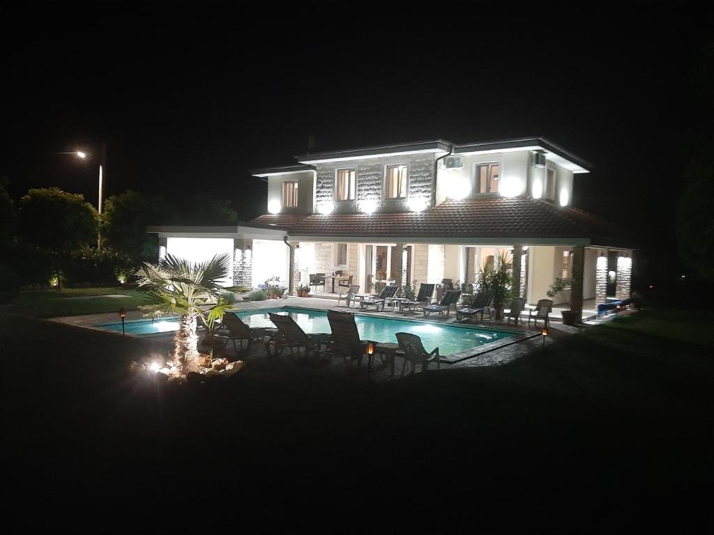 a large house with a swimming pool at night at Vila Eleonora Beograd in Belgrade