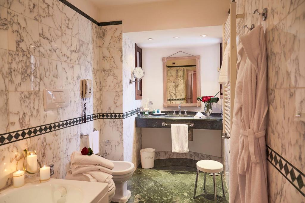 a bathroom with a sink and a toilet and a tub at Sina Palazzo Sant'Angelo in Venice