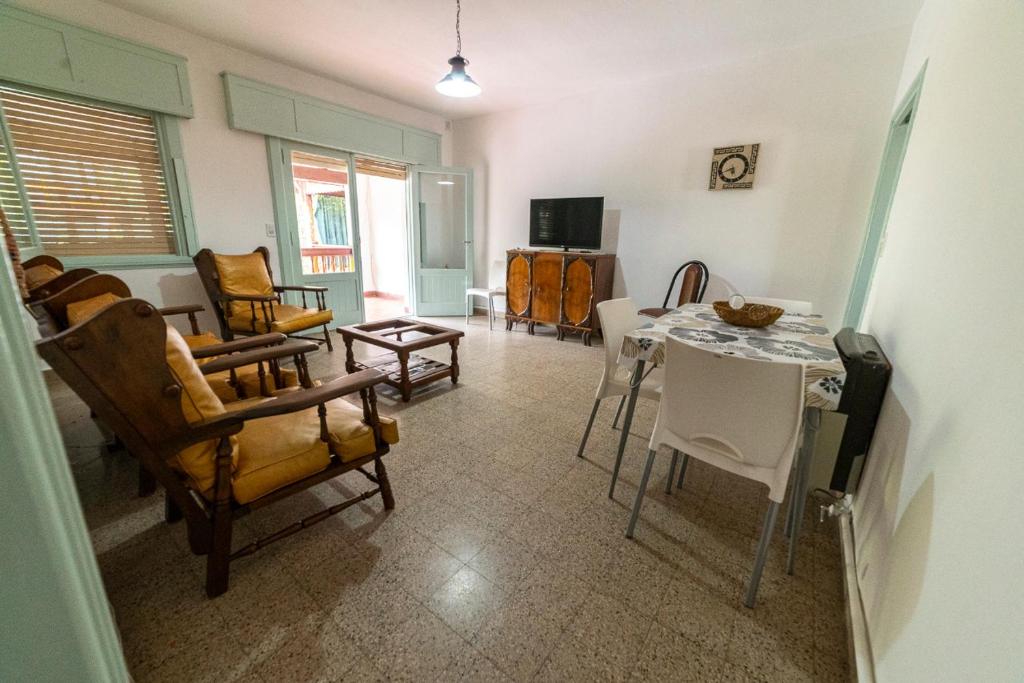 a living room with a table and chairs at Departamento centrico in Santa Rosa de Calamuchita