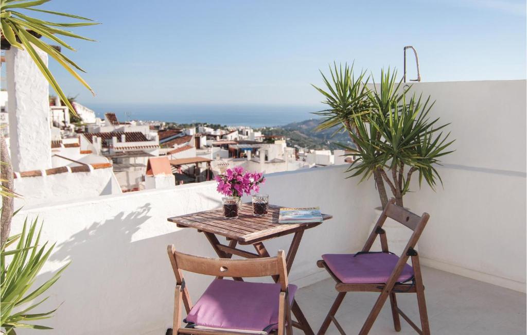 a table and chairs on a balcony with a view at Stunning Home In Frigiliana With 2 Bedrooms And Wifi in Frigiliana