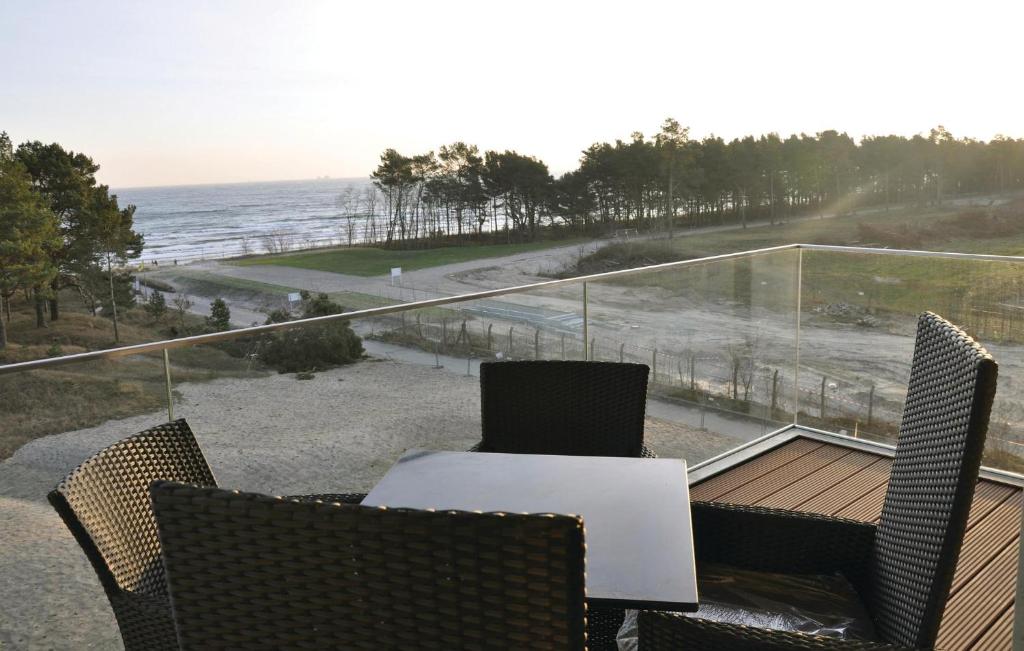 a table and chairs on a balcony with a view of the ocean at Prince in Binz