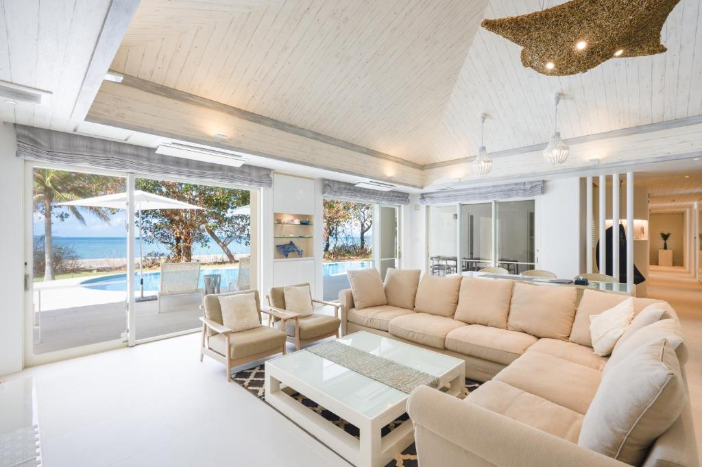 a living room with a couch and a table at Ocean Front Villa Ishigakijima Ⅲ in Ishigaki Island