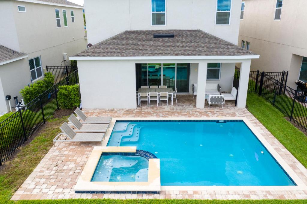 a swimming pool in the backyard of a house at Luxurious 5Bd Private Pool Jacuzzi & Game Room at Encore 7432 in Orlando