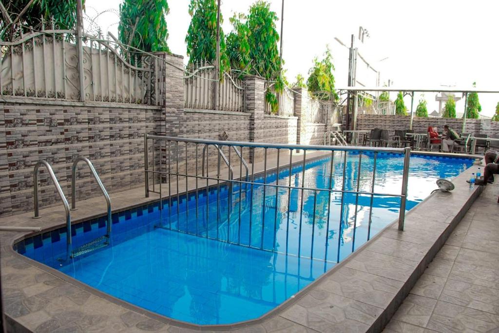 a large swimming pool with blue water at World Class Hotel & Apartments in Abuja