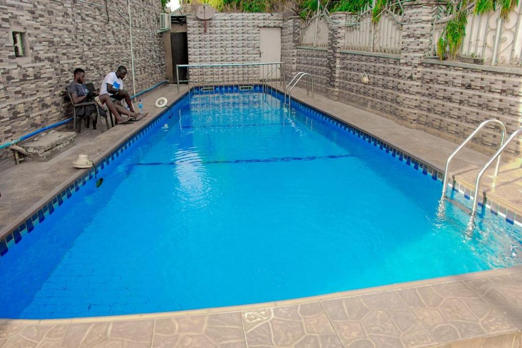 a large pool with blue water in a building at World Class Hotel & Apartments in Abuja