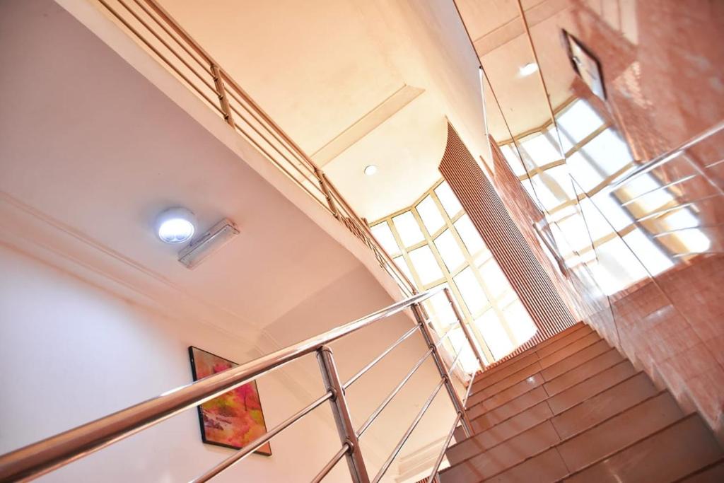 a spiral staircase in a building with a window at World Class Hotel & Apartments in Abuja