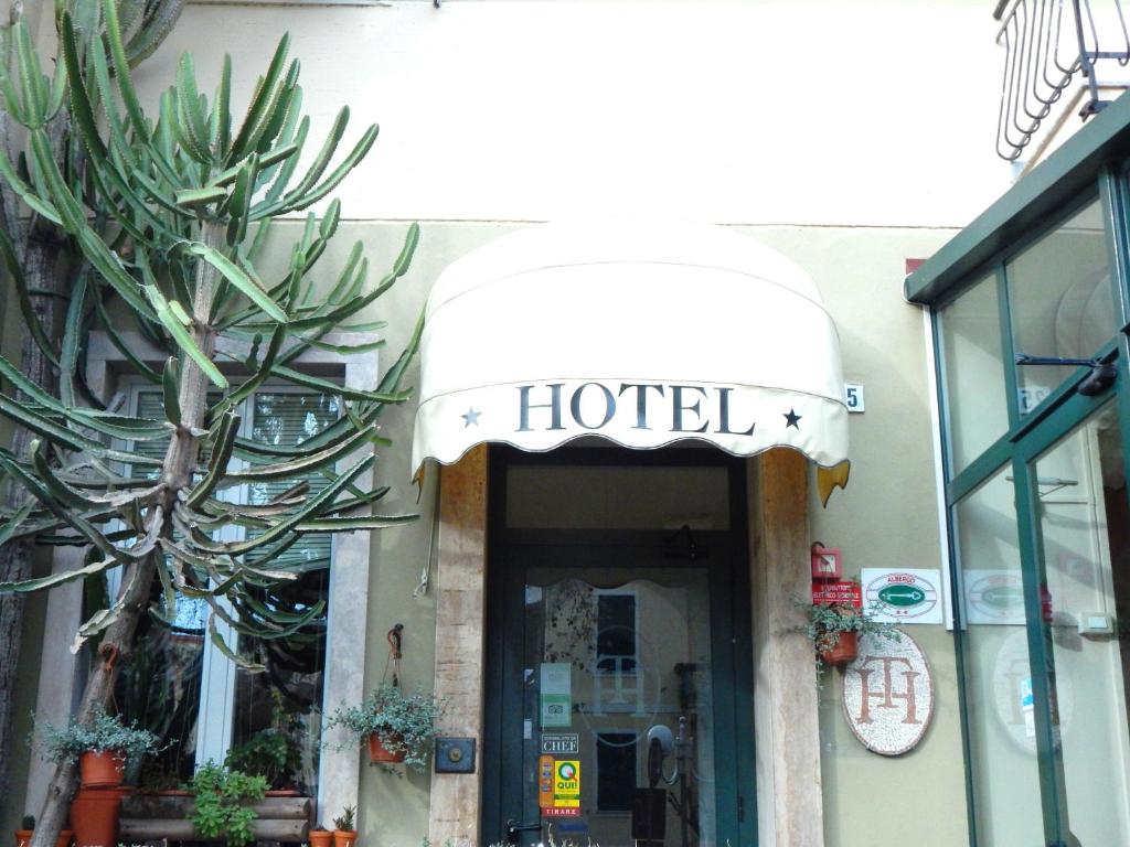 a hotel sign over the door of a building at Albergo Torino in Albenga