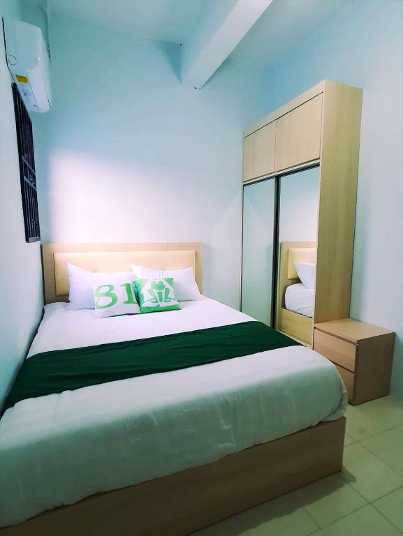 a bedroom with a large bed with two pillows at Homestay 81 Batu Batam in Nagoya