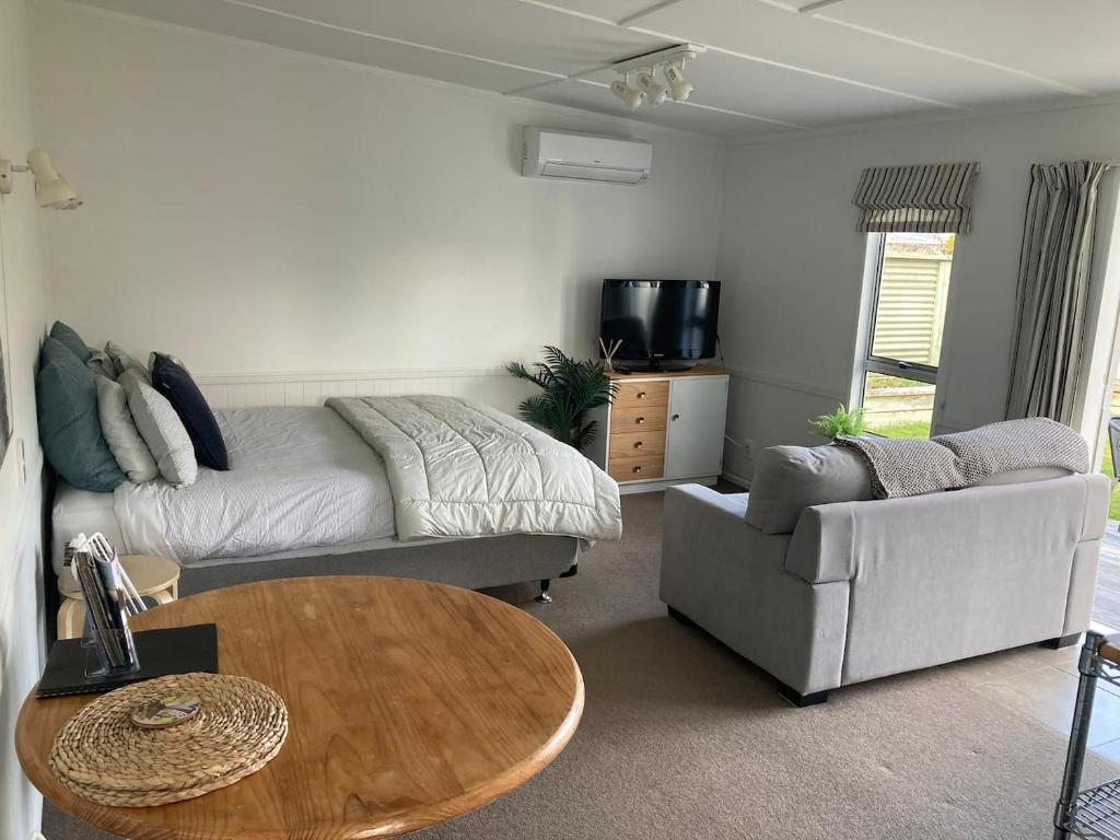 a living room with a couch and a table at Cosy Studio on Hyde in Taupo