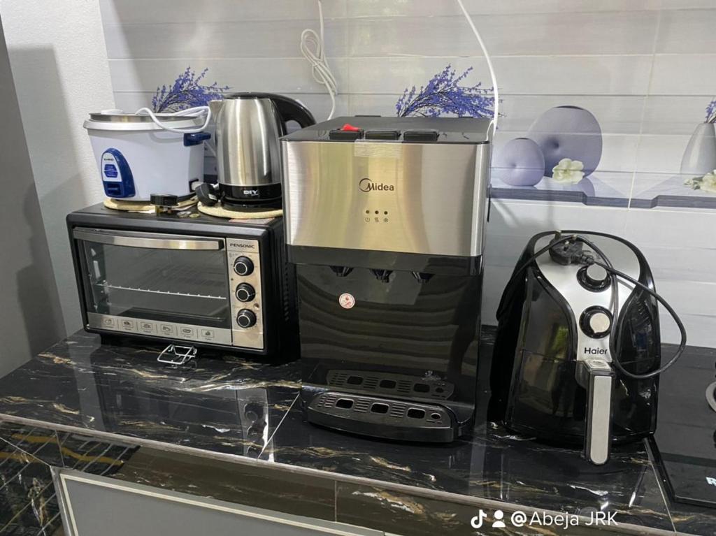 a kitchen counter with a blender and a microwave at JRK HOMESTAY A in Jertih