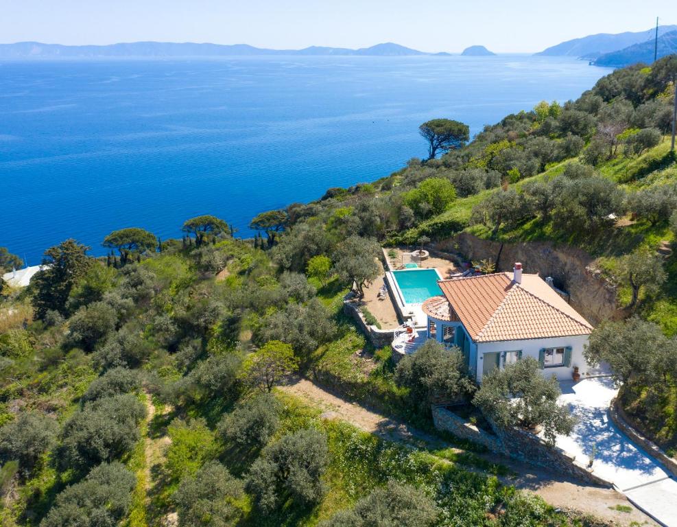 an aerial view of a house on a hill with the ocean at Avgi Villa in Glossa