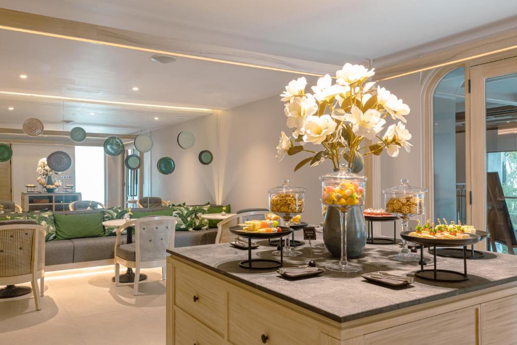 A lounge-style breakfast setting with a central display of pastries and fruit.