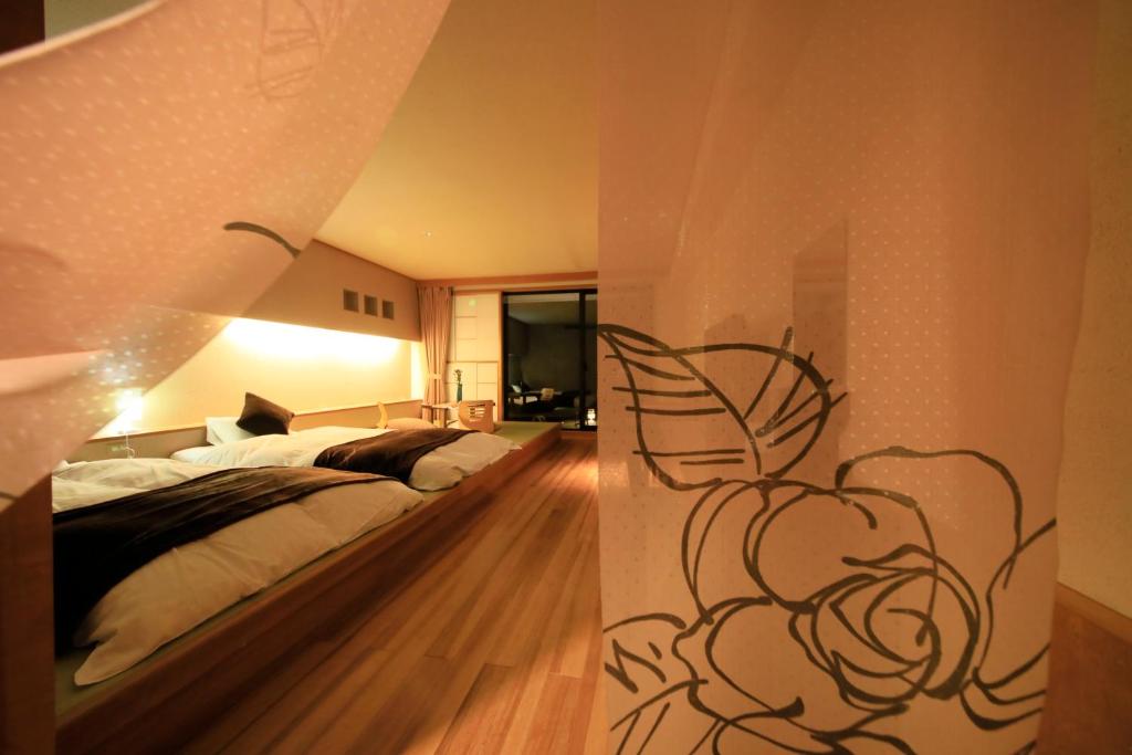 Postel nebo postele na pokoji v ubytování Hotel Shikisai