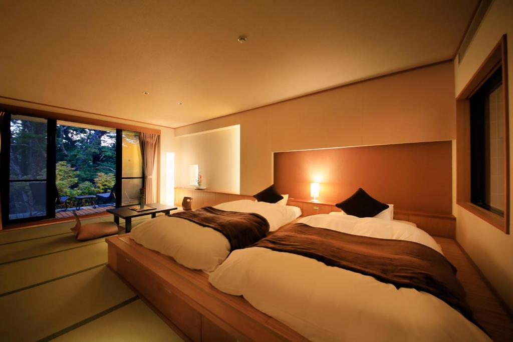 Postel nebo postele na pokoji v ubytování Hotel Shikisai