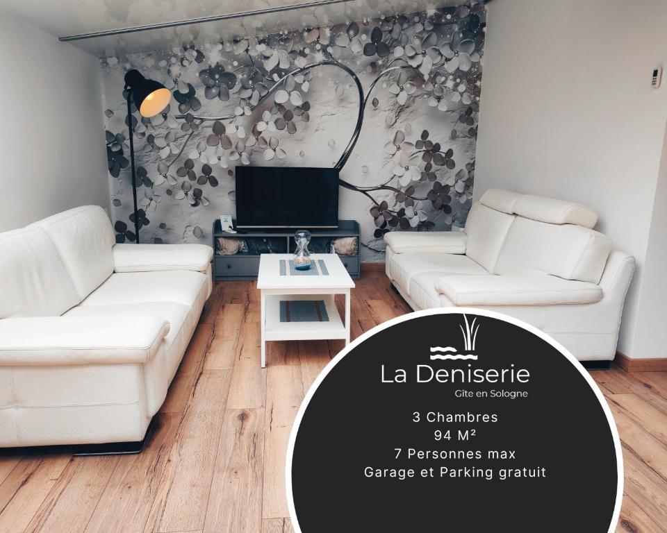 a living room with two white couches and a tv at Gîte en Sologne - La Deniserie - 94m2 avec Garage in Romorantin